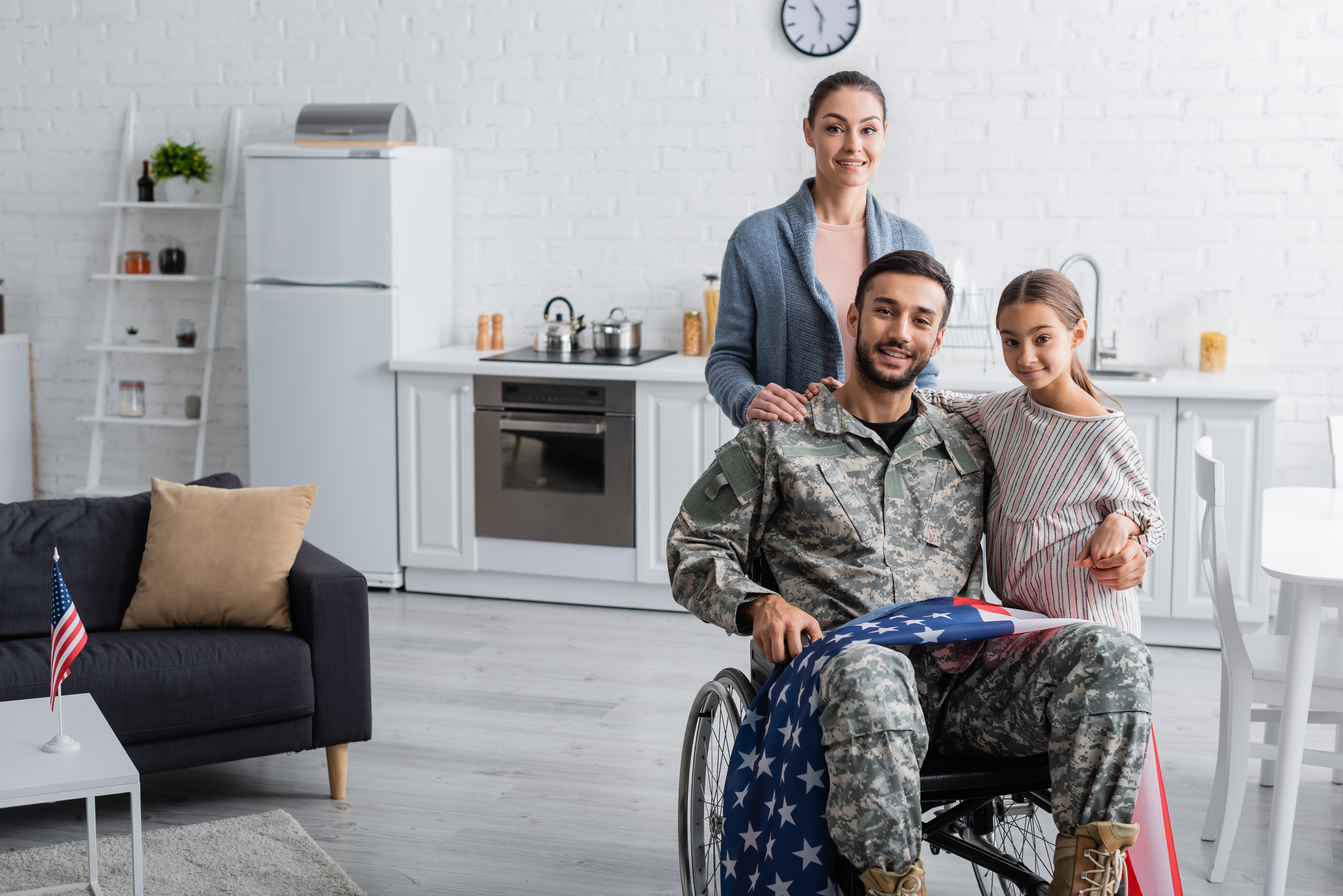 Advisor supporting a Veteran with an American flag backdrop